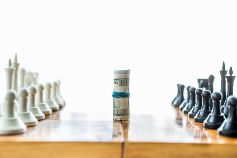 twisted money on board between rows of chess pieces